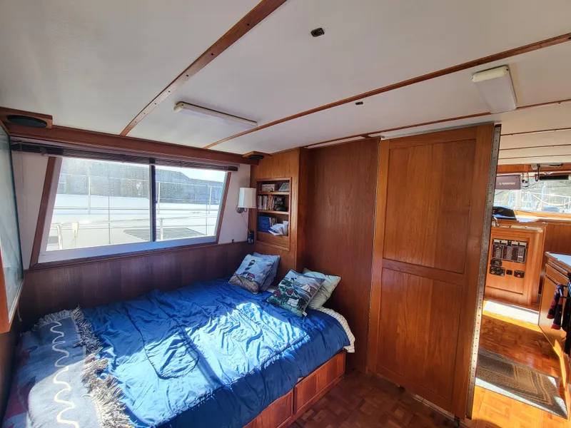 Slide: The Image of Interior of 1992 Corsair 42 boat with wood paneling and cozy seating area. - 23
