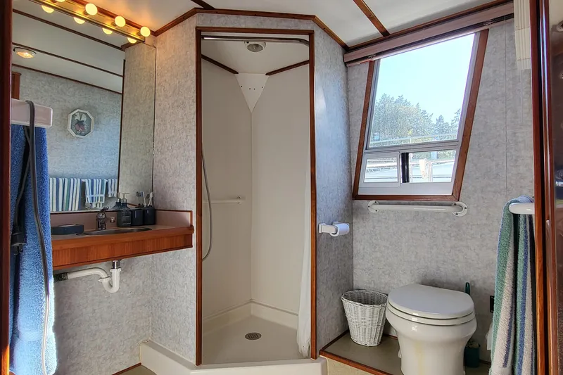 Slide: The Image of Interior hallway of a 1992 Corsair 42 boat with wooden paneling and nautical decor. - 24