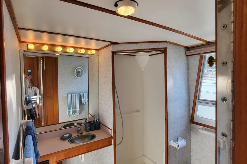 Slide: The Image of Cozy cabin interior of 1992 Corsair 42 boat with bed and window view. - 25