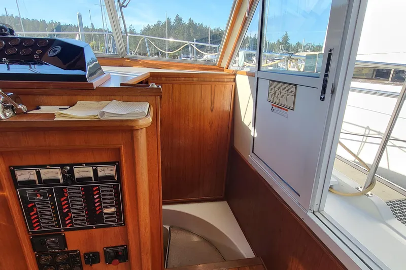 Slide: The Image of Cockpit of a 1992 Corsair 42 boat with blue canopy in a marina. - 9