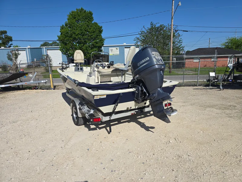 Slide: The Image of 2013 Xpress H20B boat with Yamaha outboard motor on a trailer in a parking lot. - 5