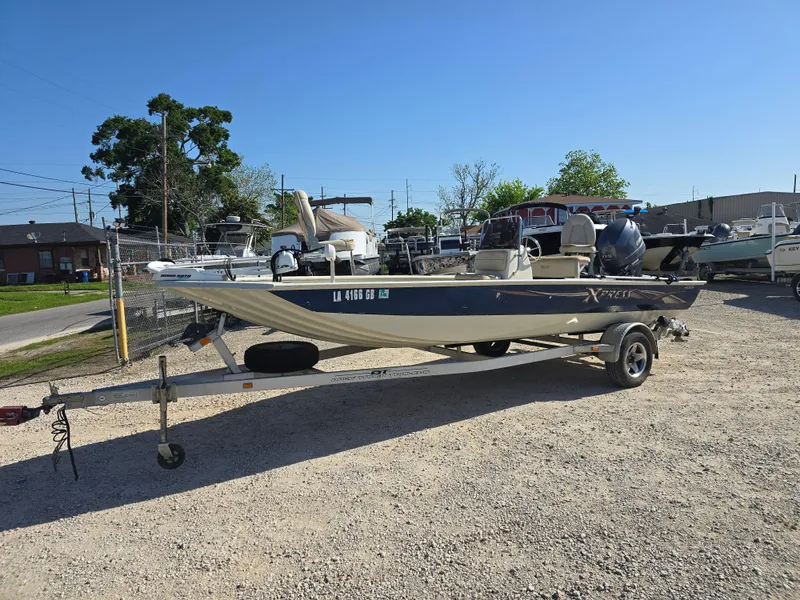 Slide: The Image of 2013 Xpress H20B boat on trailer in outdoor storage area. - 7