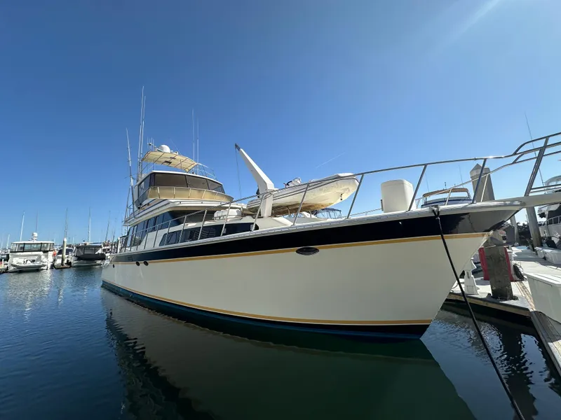 The Image of 1999 Mikelson Long-Range Luxury Sportfish yacht docked in marina under clear blue sky. - 0
