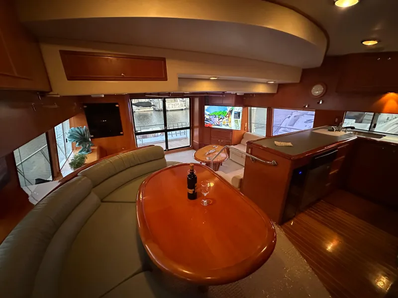 Slide: The Image of Luxurious interior of a 1999 Mikelson Long-Range Luxury Sportfish yacht with elegant seating and dining area. - 12