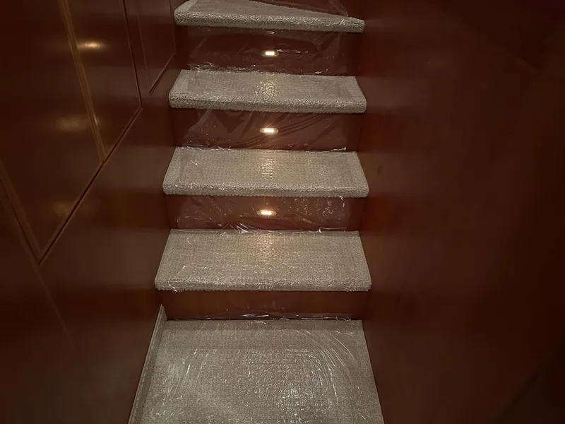 Slide: The Image of Carpeted stairs inside a 1999 Mikelson Long-Range Luxury Sportfish yacht. - 18