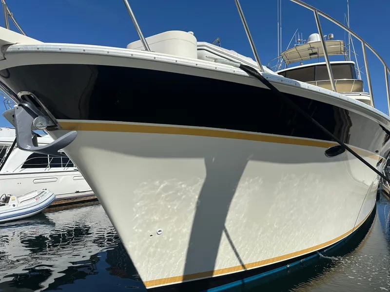 Slide: The Image of 1999 Mikelson Long-Range Luxury Sportfish boat docked, showcasing sleek design and elegant finish. - 2