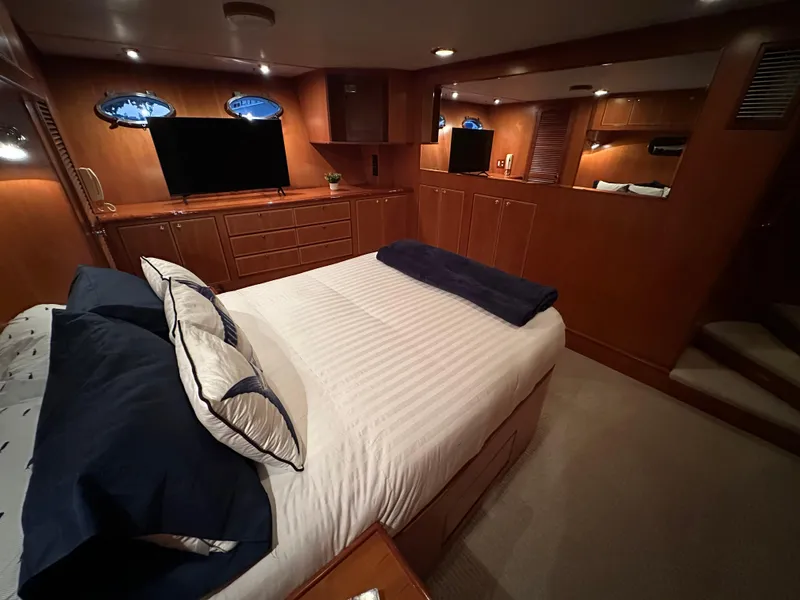 Slide: The Image of Luxurious bedroom interior of 1999 Mikelson Long-Range Luxury Sportfish yacht with elegant wood finish. - 24
