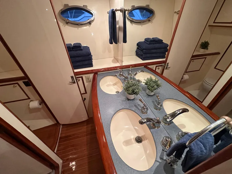Slide: The Image of Luxurious bathroom in 1999 Mikelson Long-Range Luxury Sportfish yacht with dual sinks and elegant decor. - 27