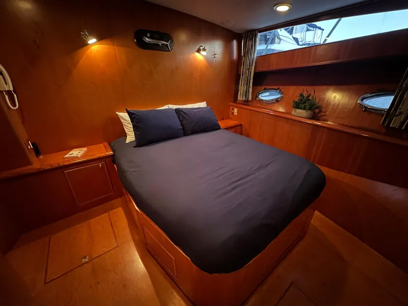 Slide: The Image of Luxurious cabin interior of 1999 Mikelson Long-Range Luxury Sportfish yacht with cozy bed. - 29
