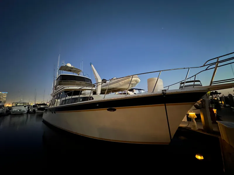 Slide: The Image of 1999 Mikelson Long-Range Luxury Sportfish yacht docked at sunset. - 3