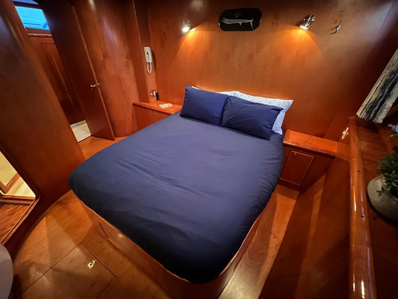 Slide: The Image of Luxurious cabin interior of 1999 Mikelson Long-Range Luxury Sportfish yacht with cozy bed. - 30