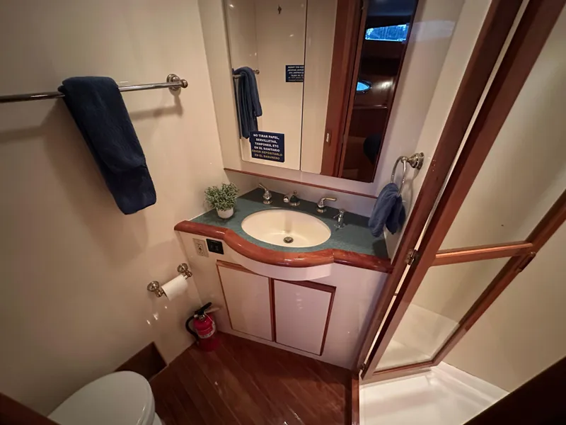 Slide: The Image of Bathroom interior of 1999 Mikelson Long-Range Luxury Sportfish yacht, featuring sink and shower. - 32