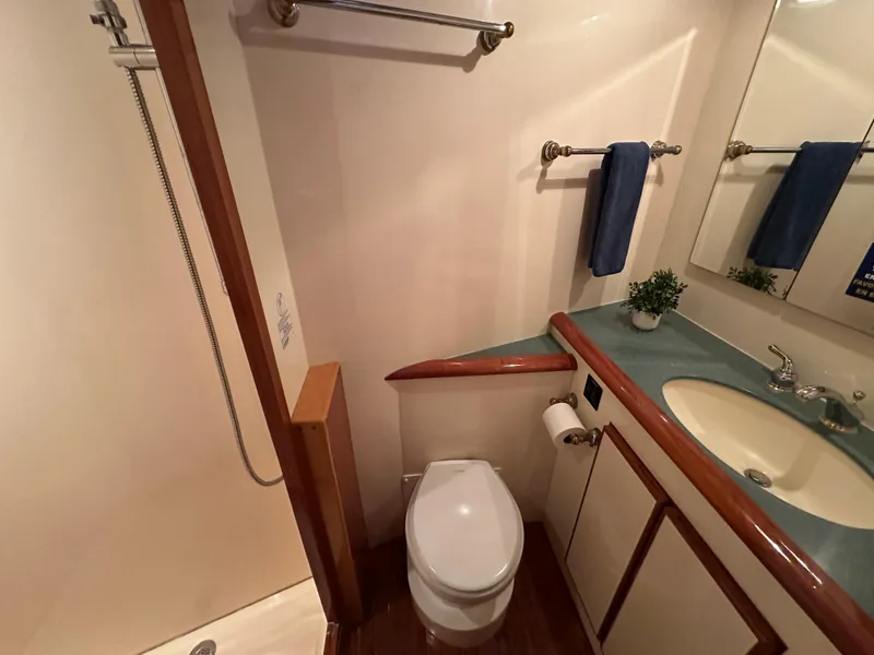 Slide: The Image of Bathroom interior of 1999 Mikelson Long-Range Luxury Sportfish yacht, featuring shower and sink. - 37