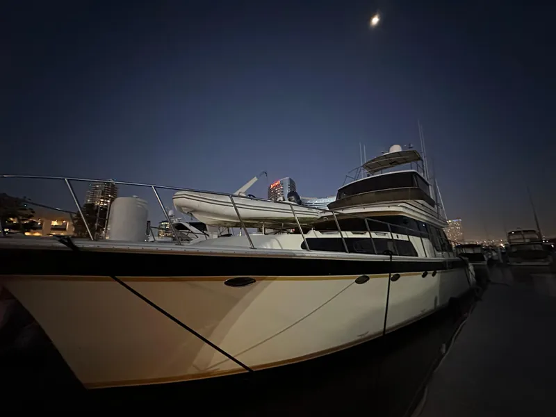 Slide: The Image of 1999 Mikelson Long-Range Luxury Sportfish yacht docked at night under moonlight. - 4