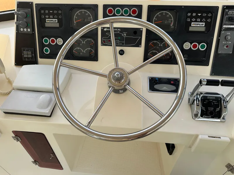 Slide: The Image of 1999 Mikelson Long-Range Luxury Sportfish helm with steering wheel and control panel. - 40