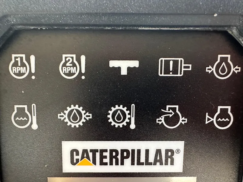 Slide: The Image of Control panel with Caterpillar logo, featuring various engine warning icons and indicators. - 41