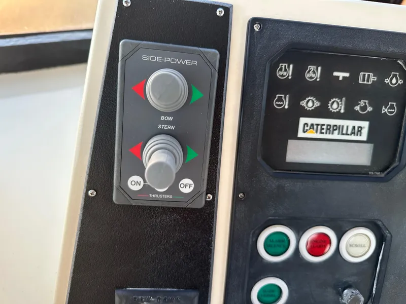 Slide: The Image of Control panel of a 1999 Mikelson Long-Range Luxury Sportfish boat with Side-Power and Caterpillar systems. - 42
