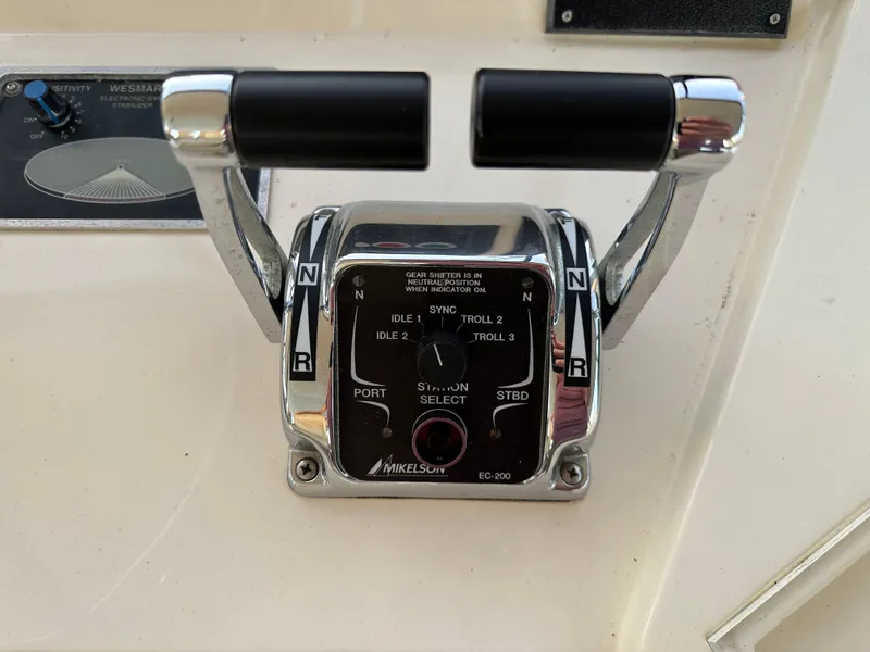 Slide: The Image of Throttle controls of a 1999 Mikelson Long-Range Luxury Sportfish boat. - 43