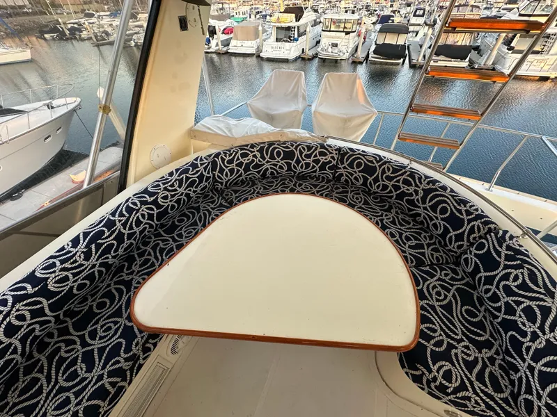 Slide: The Image of 1999 Mikelson Long-Range Luxury Sportfish yacht with elegant seating and marina view. - 45