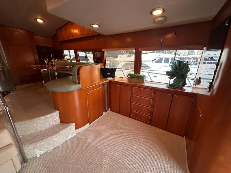 Slide: The Image of Interior of 1999 Mikelson Long-Range Luxury Sportfish yacht with wood cabinetry and seating. - 8