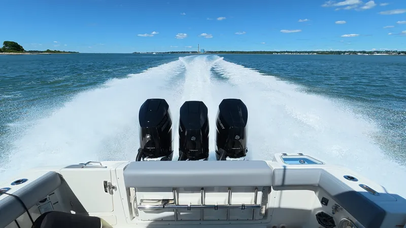 Slide: The Image of Boston Whaler 350 Realm 2026 on water with three engines. - 11
