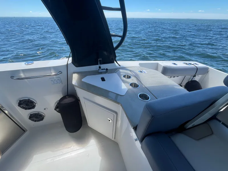 Slide: The Image of Boston Whaler 350 Realm 2026 on water with seating area. - 26