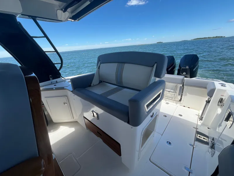 Slide: The Image of Boston Whaler 350 Realm 2026 on water with seating area. - 28