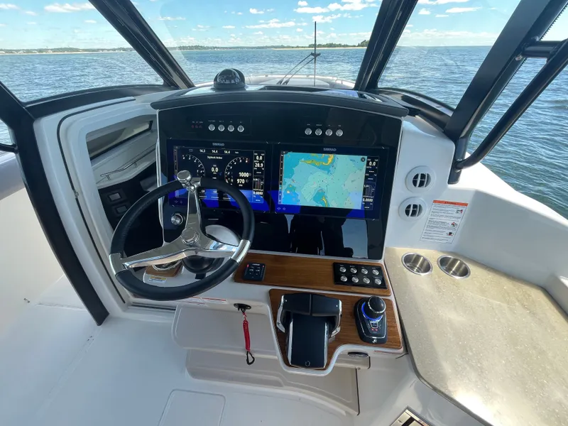 Slide: The Image of Boston Whaler 350 Realm 2026 helm on the water. - 32