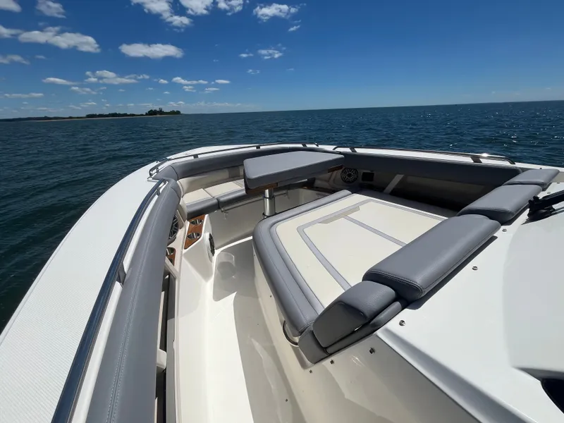 Slide: The Image of Boston Whaler 350 Realm 2026 on open sea under sunny skies. - 47