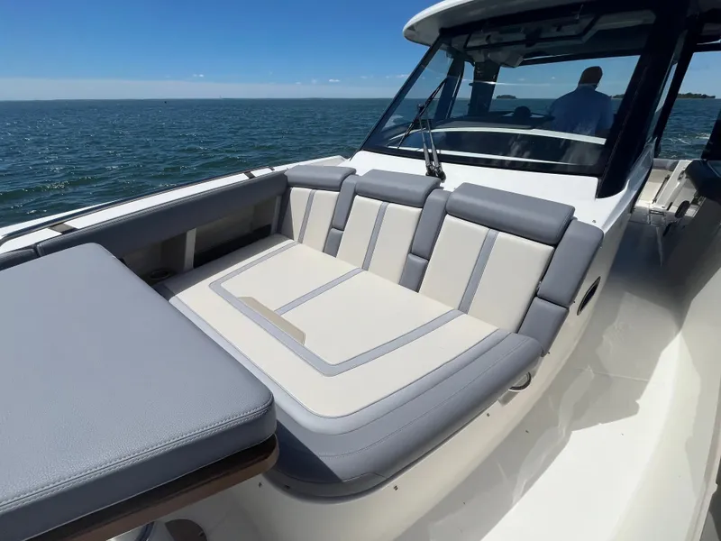 Slide: The Image of Boston Whaler 350 Realm 2026 on water with luxurious seating area. - 49