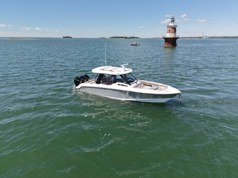 Slide: The Image of Boston Whaler 350 Realm 2026 on water near a lighthouse. - 8