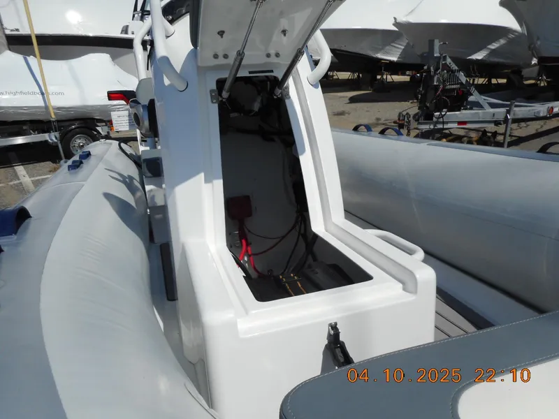Slide: The Image of 2025 Highfield Classic 400 boat with open storage compartment, docked outdoors. - 10