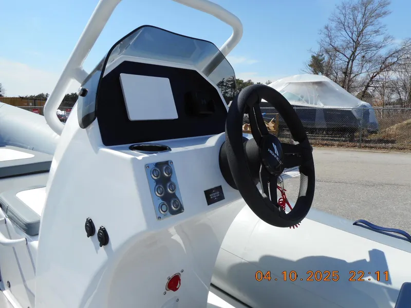 Slide: The Image of Highfield Classic 400 boat dashboard, 2025 model, featuring steering wheel and control panel. - 12