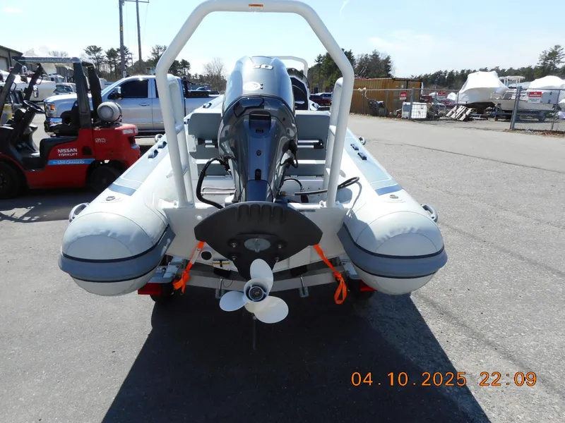 Slide: The Image of 2025 Highfield Classic 400 inflatable boat with outboard motor, parked outdoors. - 3