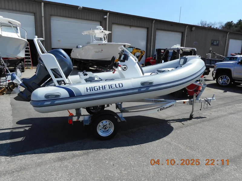 Slide: The Image of 2025 Highfield Classic 400 inflatable boat on trailer, parked outdoors. - 5
