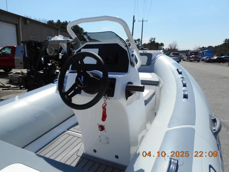 Slide: The Image of Highfield Classic 400 boat, 2025 model, featuring a sleek steering console and spacious seating. - 6
