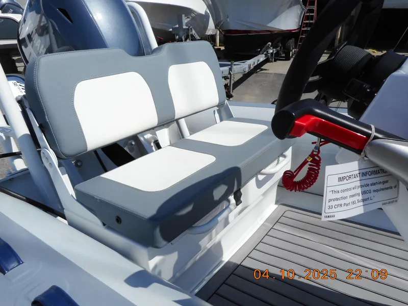Slide: The Image of Highfield Classic 400 boat interior, featuring dual cushioned seats and steering wheel, 2025 model. - 7