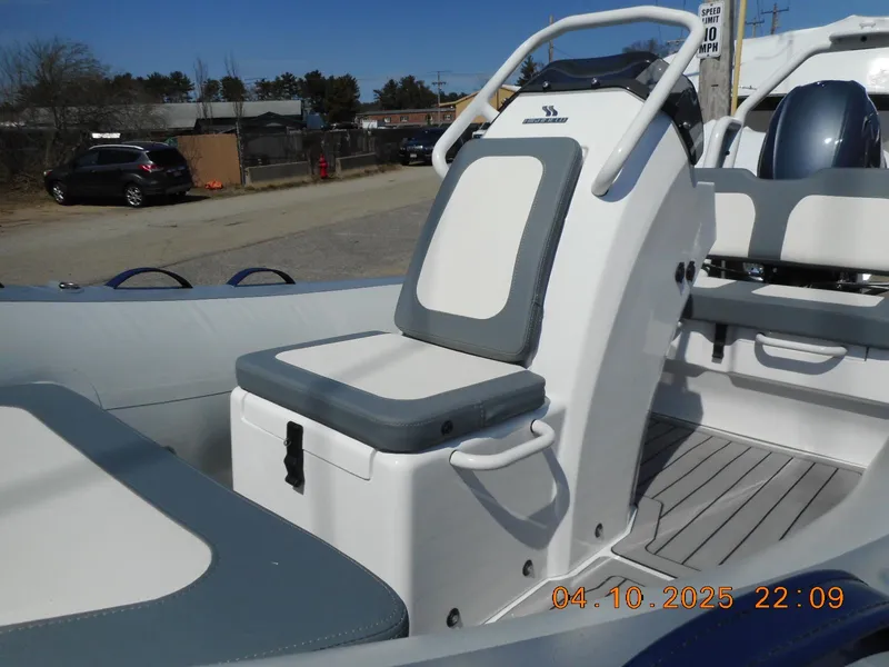 Slide: The Image of 2025 Highfield Classic 400 boat interior with cushioned seating and steering console. - 9