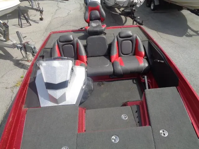 Slide: The Image of 2016 Ranger Z175 boat interior with red and black seating, gray carpet, and steering console. - 6