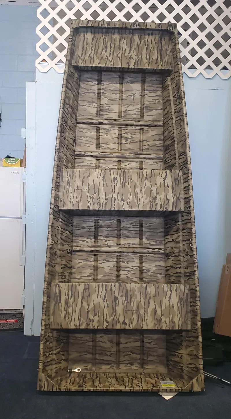 Slide: The Image of 2025 Starcraft JON 1032 boat, camouflage pattern, displayed vertically indoors. - 3