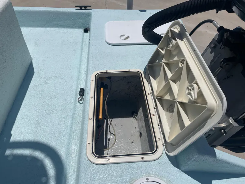 Slide: The Image of Open storage compartment on a 2006 Explorer 19 boat, showing interior details. - 10