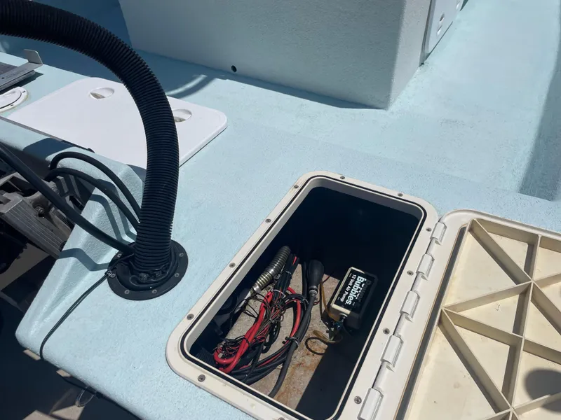 Slide: The Image of Open hatch on 2006 Explorer 19 boat showing wiring and equipment inside. - 11