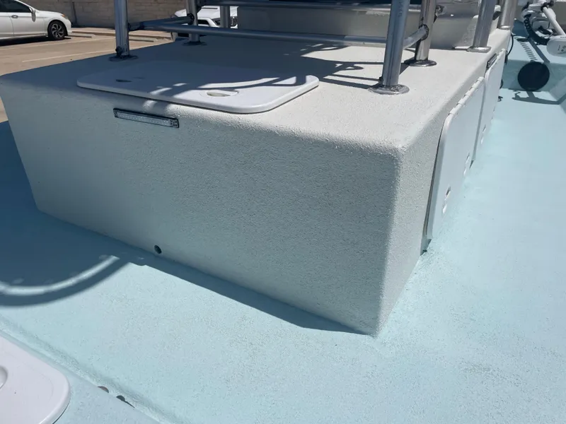 Slide: The Image of 2006 Explorer 19 boat deck with storage compartment and metal railings. - 12