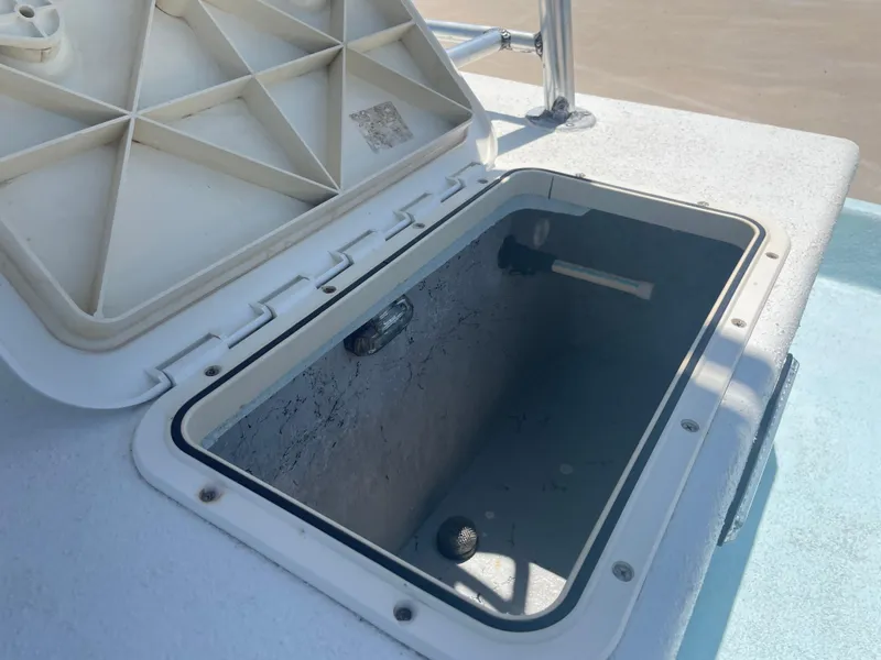 Slide: The Image of Open storage compartment on a 2006 Explorer 19 boat, showing interior details. - 13