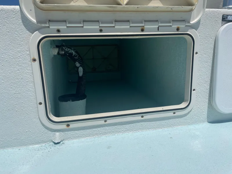 Slide: The Image of Open storage compartment on a 2006 Explorer 19 boat. - 14