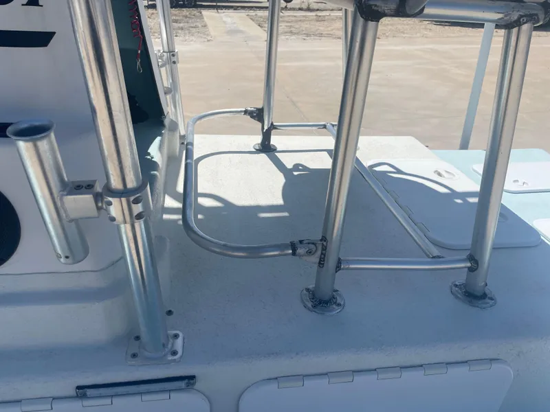 Slide: The Image of 2006 Explorer 19 boat deck with metal railings and rod holder. - 18