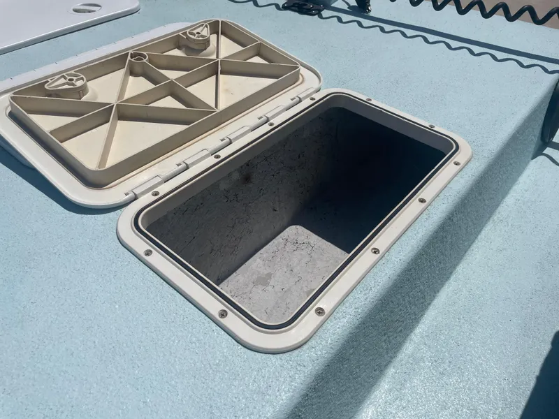 Slide: The Image of Open storage compartment on a 2006 Explorer 19 boat deck. - 30