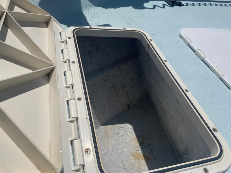 Slide: The Image of Open storage compartment on 2006 Explorer 19 boat, showing interior details. - 31
