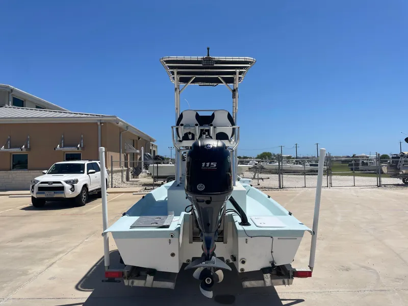 Slide: The Image of 2006 Explorer 19 boat with Yamaha 115 outboard motor, parked in a sunny lot. - 6