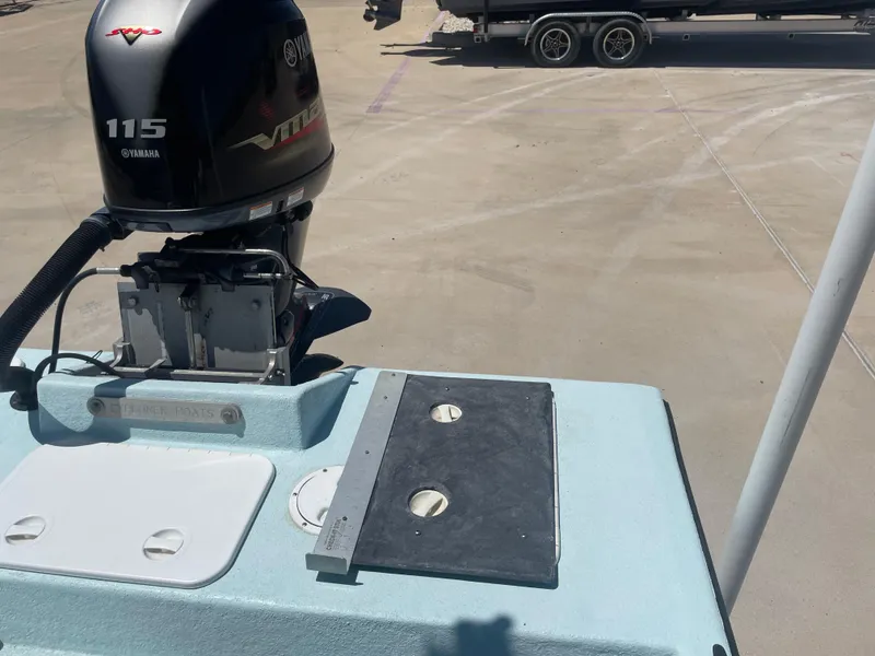 Slide: The Image of Outboard motor on 2006 Explorer 19 boat, parked on concrete surface. - 8